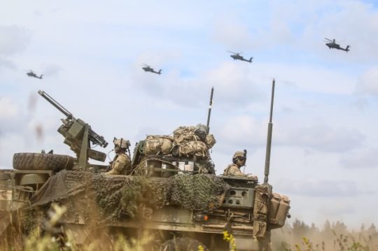 An Interim Armored Vehicle "Stryker" and AH-64 Apache helicopters with Battle Group Poland move to secure an area during a lethality demonstration as part of Saber Strike 18 in June 2018. (Photo: U.S. Army/Spc. Hubert D. Delany III, 22nd Mobile Public Affairs Detachment)