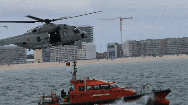 As part of the Operation Shark Bait test of Galileo Search and Rescue, Belgian Coast Guard boat Orka R6 dashed out to sea, guided by a positioning precision of less than 2 km, joined by an NH90 Caiman helicopter. In the test scenario, the patient had been burned and required medical evacuation to hospital. Once Tara was taken aboard the ship, she was winched aboard the helicopter. (Video: ESA–I. Stojkovic)