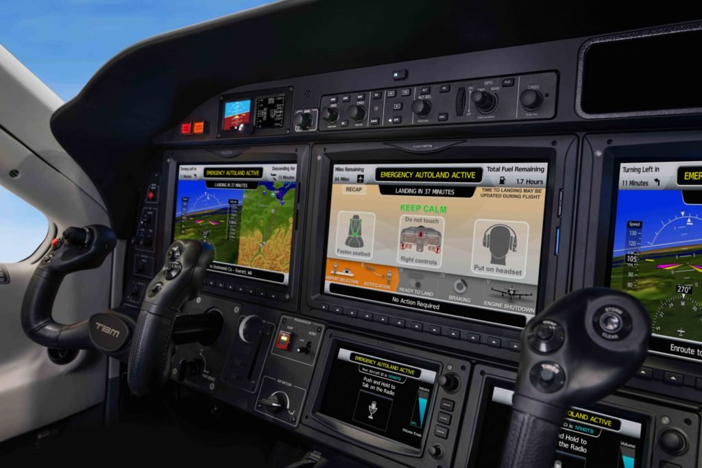 Daher TBM 940 cockpit with screens showcasing Garmin Autoland activation. 