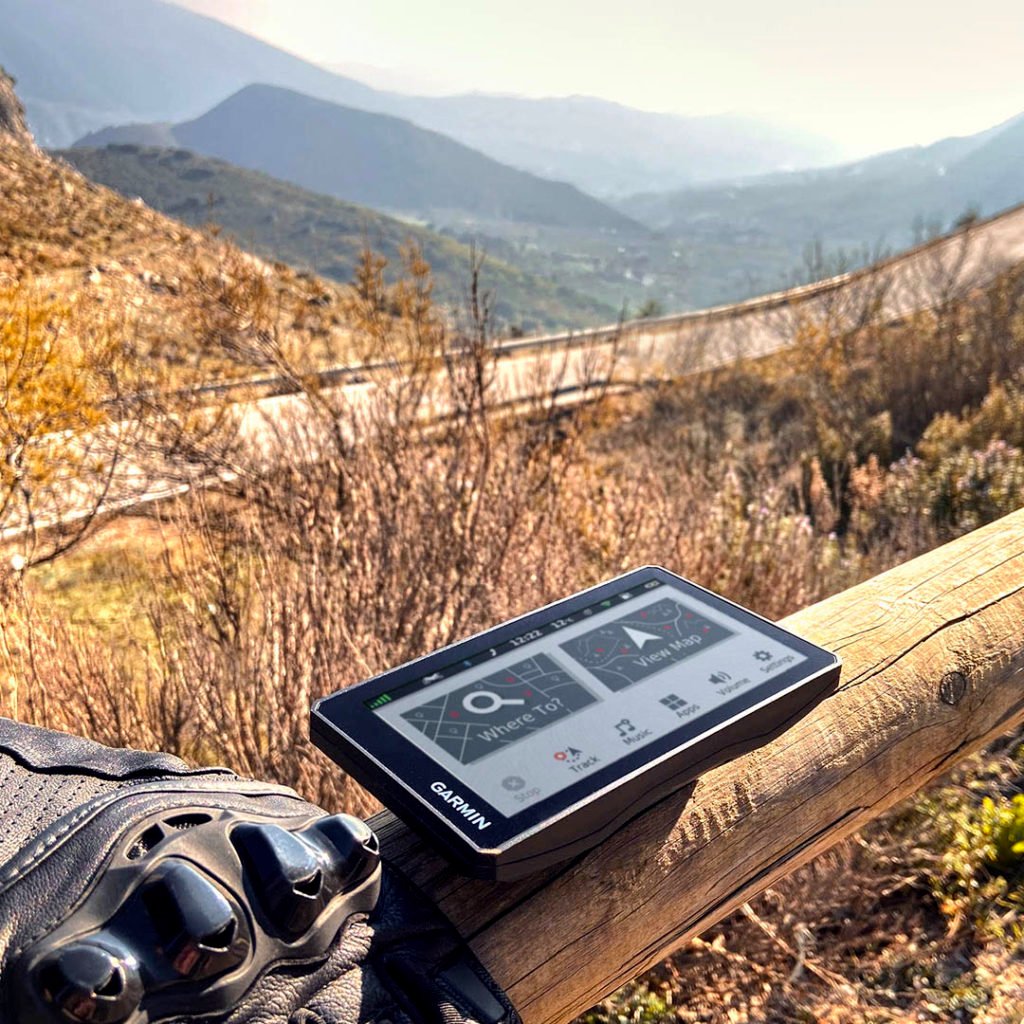 Garmin zūmo XT all-terrain motorcycle navigator resting on fence by road