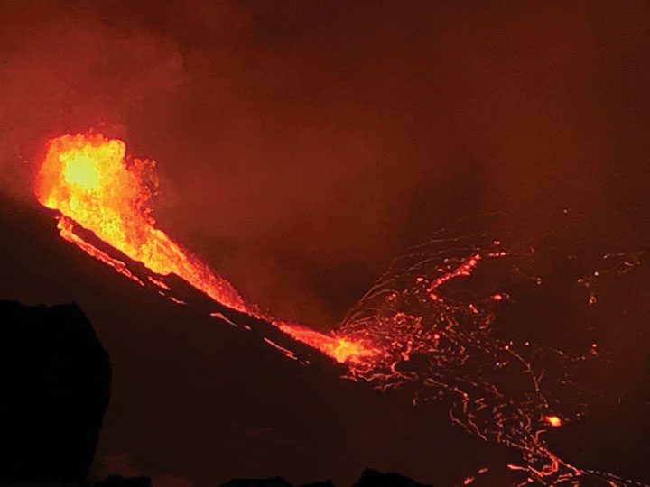 The water lake at the base of Halema‘uma‘u crater has been replaced with a growing lava lake. View from the west rim of Kīlauea Caldera just before 5 a.m. HST on Dec. 21, 2020. A 59-foot fountain joins two other fissures to feed a growing lava lake at the base of Halema‘uma‘u crater. (Photo: USGS)