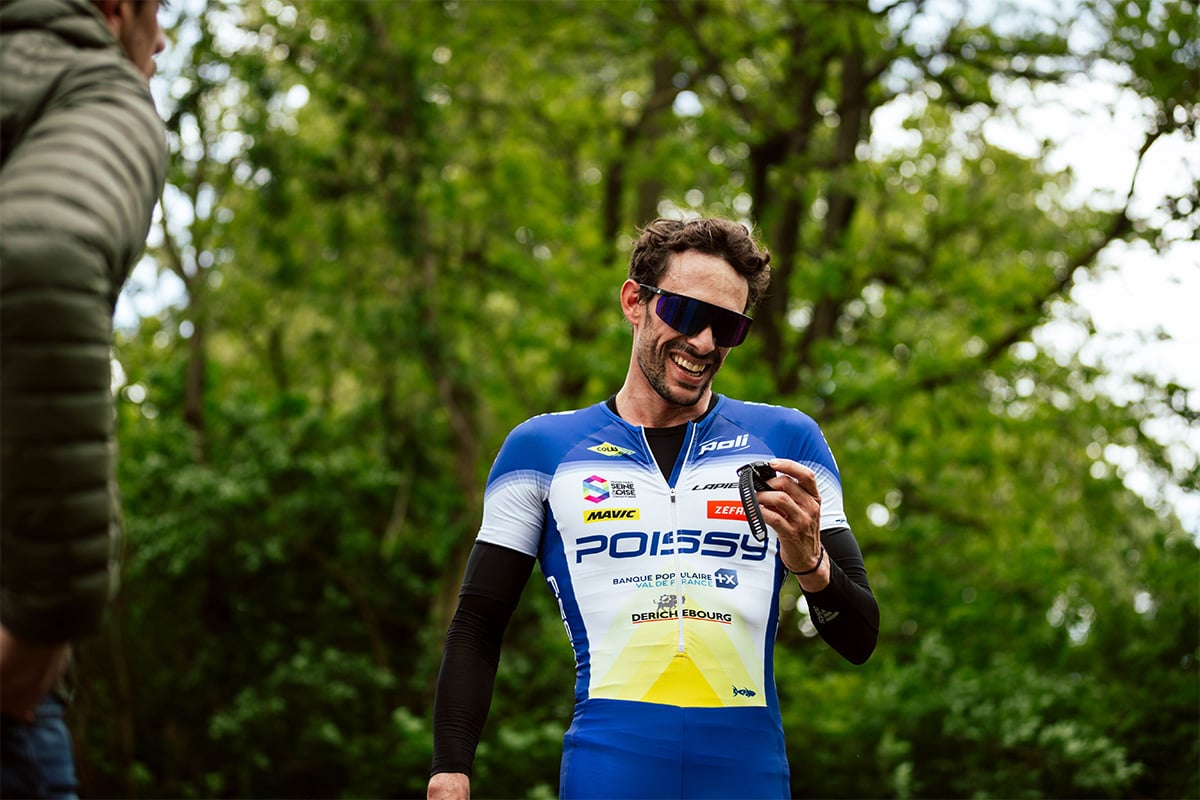 Dorian Coninx smiles as he looks down at his smartwatch.