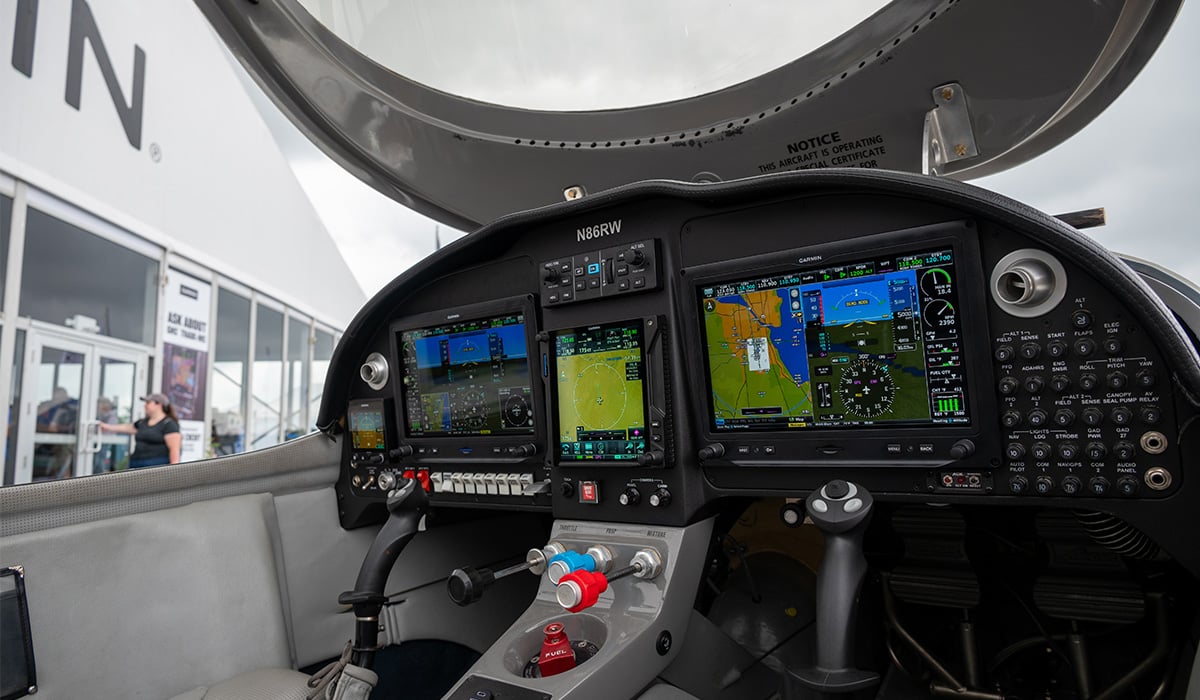 The aircraft of Henry Lawrence, a Garmin ambassador and aviation enthusiast, sits next to the Garmin tent at the 2024 EAA AirVenture in Oshkosh, Wisconsin. A fresh suite of Garmin avionics appears in the cockpit in the image.