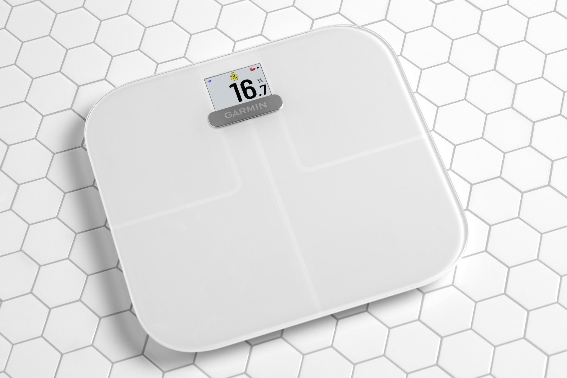 White smart scale on a white tile background.