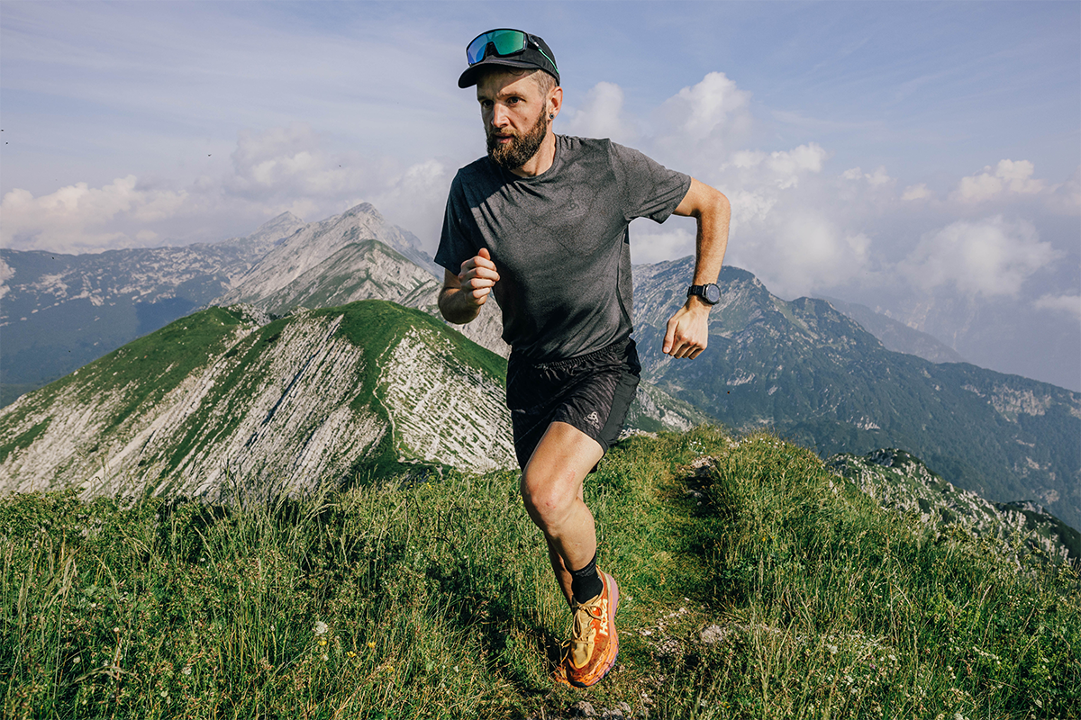 Jake Catterall, wearing an Enduro 2 smartwatch, runs across the Alps mountains.