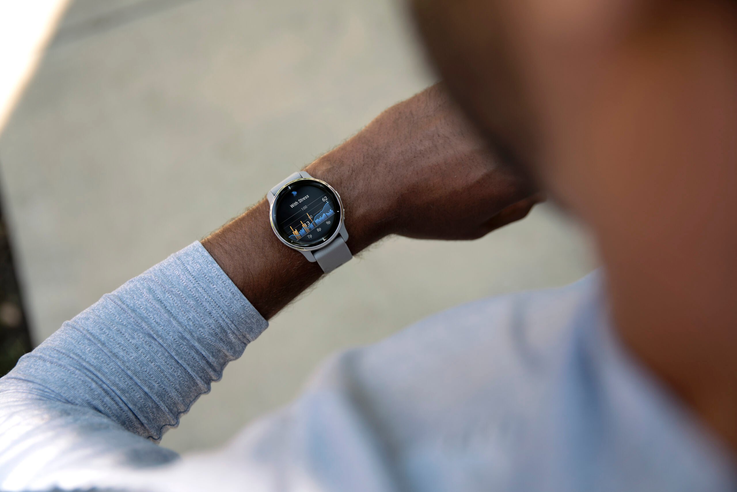 A Garmin watch users glances down at his stress levels displayed on his smartwatch.
