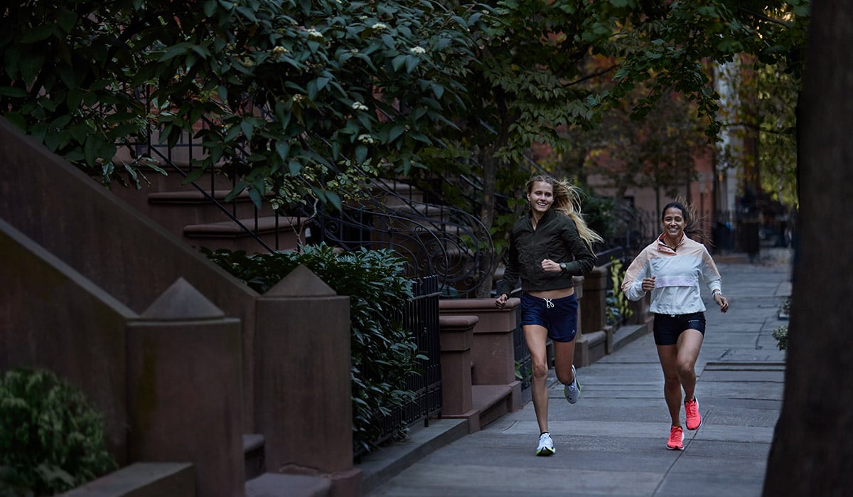 Women run with Garmin smartwatches