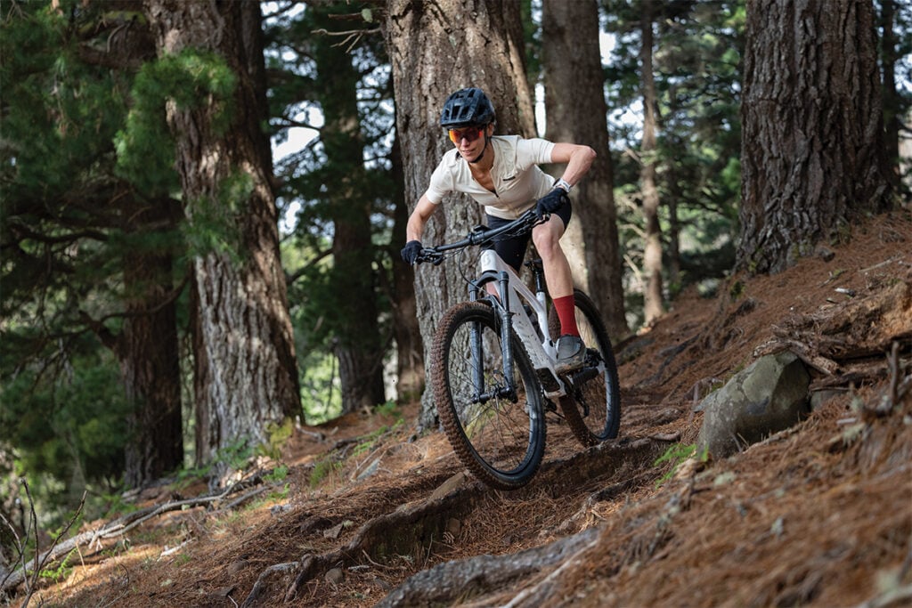 A mountain biker rides a trail equipped with Garmin Edge MTB.