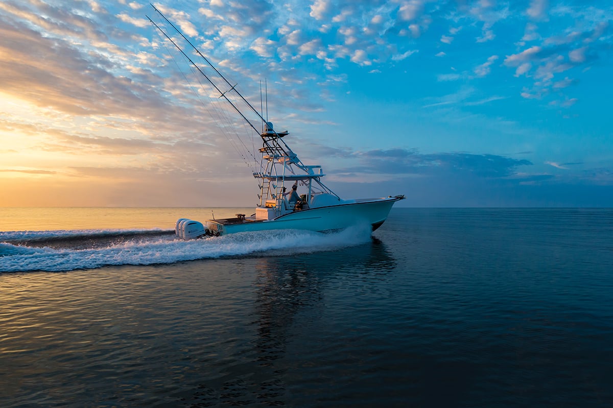 A boat cruising in the sunset.
