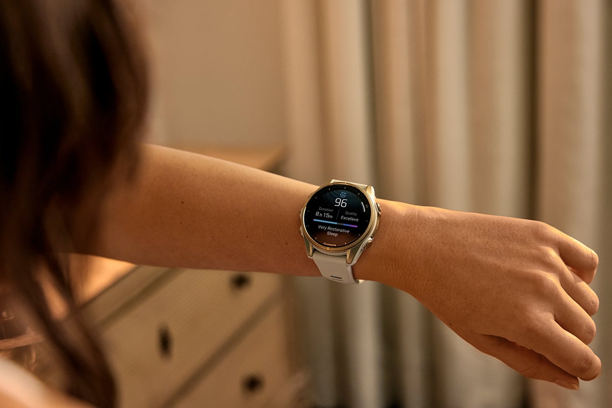 A woman wearing the Garmin Venu 4 smartwatch checks her Garmin sleep score.