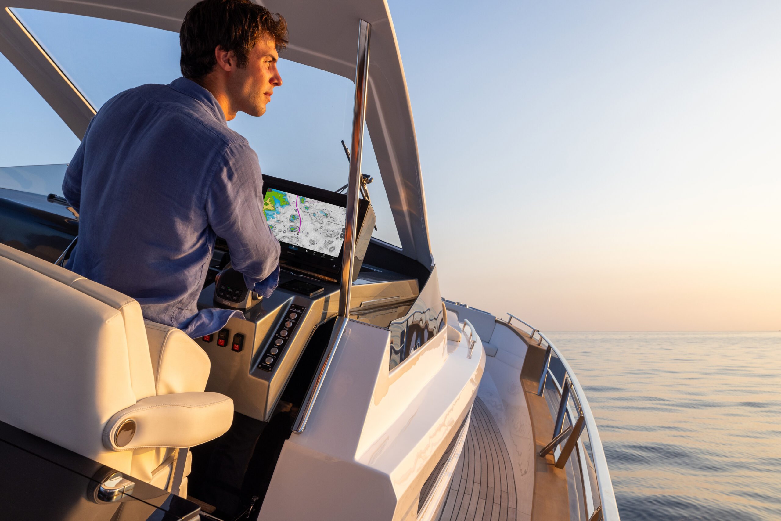Someone at the helm using Navionics mapping on their chartplotter to navigate.