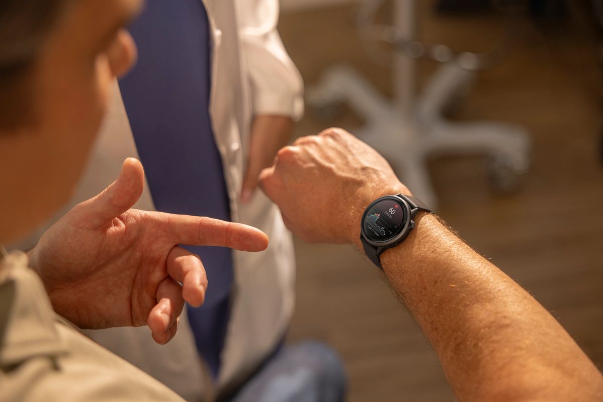 A man wearing a Garmin smartwatch checks his resting heart rate.