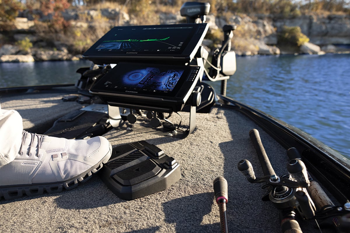 Anglers foot on the foot pedal with sonar on the chartplotter display.
